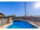 Private pool with a safety fence surrounded by a well-maintained gravel backyard at 1620 N 72Nd Ln, Phoenix, AZ 85035