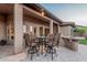 Covered back patio featuring an outdoor dining area and serving bar, ideal for entertaining guests at 16422 W Alvarado Dr, Goodyear, AZ 85395