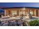 Backyard with outdoor kitchen, fire pit, pond, and desert landscaping at 16422 W Alvarado Dr, Goodyear, AZ 85395