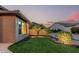 Landscaped backyard with artificial grass, rocks, and desert plants at 16422 W Alvarado Dr, Goodyear, AZ 85395