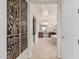 Hallway leading to the spacious bathroom with tile floor and elegant decor at 16422 W Alvarado Dr, Goodyear, AZ 85395