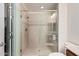 Bathroom featuring a glass enclosed shower with tiled walls and rainfall shower head at 16422 W Alvarado Dr, Goodyear, AZ 85395