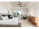 Cozy bedroom with neutral tones, tile flooring, and tray ceilings at 16422 W Alvarado Dr, Goodyear, AZ 85395