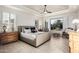 Bright bedroom featuring tile flooring, large windows, and comfortable furniture at 16422 W Alvarado Dr, Goodyear, AZ 85395