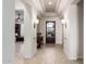 Elegant foyer with tile flooring, stylish lighting, and a view into the living area at 16422 W Alvarado Dr, Goodyear, AZ 85395