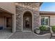 Close-up of the entrance with stone archway at 16422 W Alvarado Dr, Goodyear, AZ 85395
