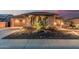 Well-maintained front yard with desert landscaping, landscape lighting, and a view of the garage at 16422 W Alvarado Dr, Goodyear, AZ 85395