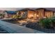 Beautifully landscaped front yard with stone accents, desert plants, and a curved walkway at 16422 W Alvarado Dr, Goodyear, AZ 85395