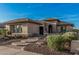 Beautifully landscaped front yard, highlighted by the brick walkway and desert vegetation at 16422 W Alvarado Dr, Goodyear, AZ 85395