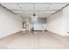 Spacious garage with epoxy floors, storage cabinets, and ample room for vehicles at 16422 W Alvarado Dr, Goodyear, AZ 85395