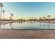 View of community golf course with trees and lake at 16422 W Alvarado Dr, Goodyear, AZ 85395