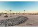 View of the golf course's desert landscape, lake, desert trees, and rocks at 16422 W Alvarado Dr, Goodyear, AZ 85395