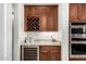 Bar area features granite counters, wine cooler, wine rack and lots of cabinets at 16422 W Alvarado Dr, Goodyear, AZ 85395