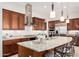 Bright kitchen with a large center island, stainless hood, and pendant lighting at 16422 W Alvarado Dr, Goodyear, AZ 85395