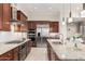 Kitchen showcases stainless steel appliances, granite countertops, and warm cabinetry at 16422 W Alvarado Dr, Goodyear, AZ 85395