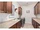 Laundry room with built in cabinets, stainless steel washer and dryer, and utility sink at 16422 W Alvarado Dr, Goodyear, AZ 85395