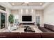 Open-concept living room with sleek fireplace, tile flooring, and modern decor at 16422 W Alvarado Dr, Goodyear, AZ 85395