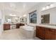 Bright bathroom featuring a large tub, vanity, and tile flooring at 16422 W Alvarado Dr, Goodyear, AZ 85395