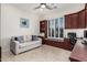 Bright office featuring a white sofa, custom cabinets, and a window seat with shutters at 16422 W Alvarado Dr, Goodyear, AZ 85395