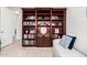 Office bookshelves with a white sofa, providing ample storage and display space at 16422 W Alvarado Dr, Goodyear, AZ 85395