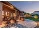 Outdoor dining area with bar, patio furniture, and manicured lawn at 16422 W Alvarado Dr, Goodyear, AZ 85395