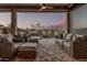 Covered patio featuring comfortable seating and picturesque lake views at 16422 W Alvarado Dr, Goodyear, AZ 85395