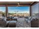 Inviting covered patio with ample seating and scenic lake views at 16422 W Alvarado Dr, Goodyear, AZ 85395