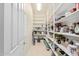 Walk-in pantry provides ample storage with built-in shelving for organization at 16422 W Alvarado Dr, Goodyear, AZ 85395