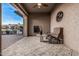 Covered patio with fireplace and comfortable seating, perfect for outdoor relaxation at 16422 W Alvarado Dr, Goodyear, AZ 85395