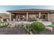 Covered patio with an outdoor kitchen, dining table, and firepit for outdoor living at 16422 W Alvarado Dr, Goodyear, AZ 85395