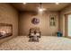 Enclosed patio featuring a fireplace, ceiling fan, and tiled flooring at 16422 W Alvarado Dr, Goodyear, AZ 85395