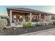 Spacious covered patio featuring an outdoor kitchen, firepit, and comfortable seating at 16422 W Alvarado Dr, Goodyear, AZ 85395