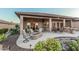 Covered patio with an outdoor firepit, living room seating, and an outdoor dining table at 16422 W Alvarado Dr, Goodyear, AZ 85395