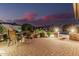 Cozy outdoor patio with brick flooring, dining table, and outdoor fireplace at 16422 W Alvarado Dr, Goodyear, AZ 85395
