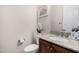 Powder room with granite counters, framed mirror, and a white flower accent at 16422 W Alvarado Dr, Goodyear, AZ 85395