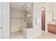 Walk-in shower featuring glass surround and tiled walls with decor strip at 16422 W Alvarado Dr, Goodyear, AZ 85395