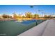 An image of outdoor tennis courts on a sunny day, surrounded by greenery at 16422 W Alvarado Dr, Goodyear, AZ 85395