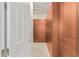 Long walk-in closet featuring built-in wood storage and carpeted floor at 16422 W Alvarado Dr, Goodyear, AZ 85395