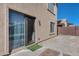 Cozy backyard features a sliding glass door, rock landscaping, and privacy fence at 1673 S 218Th Ave, Buckeye, AZ 85326