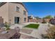 Home has a spacious backyard with rock landscaping, outdoor seating, and artifical turf at 1673 S 218Th Ave, Buckeye, AZ 85326
