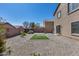 The expansive backyard offers rock landscaping, a storage shed, and artificial turf at 1673 S 218Th Ave, Buckeye, AZ 85326