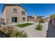 Backyard showcasing low-maintenance gravel, artificial turf, and well-kept landscaping at 1673 S 218Th Ave, Buckeye, AZ 85326