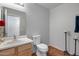 A clean, well-maintained half bathroom features a light vanity and neutral-toned walls and flooring at 1673 S 218Th Ave, Buckeye, AZ 85326