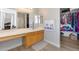 Bright bathroom with a vanity and view into the closet and main bedroom at 1673 S 218Th Ave, Buckeye, AZ 85326