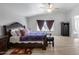 Bright bedroom boasts a vaulted ceiling, ceiling fan, and wood-look flooring at 1673 S 218Th Ave, Buckeye, AZ 85326