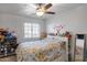 Bedroom featuring a queen size bed with flowers, ceiling fan, and closet at 1673 S 218Th Ave, Buckeye, AZ 85326