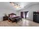 Spacious bedroom boasts a vaulted ceiling, ceiling fan, and wood-look flooring at 1673 S 218Th Ave, Buckeye, AZ 85326