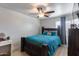 Bedroom with a wooden bed frame, a ceiling fan, and a window at 1673 S 218Th Ave, Buckeye, AZ 85326