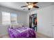 Bright bedroom with a ceiling fan, and large window view with a spacious closet at 1673 S 218Th Ave, Buckeye, AZ 85326