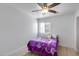 Cozy bedroom features a ceiling fan, light wood floor and a bright window at 1673 S 218Th Ave, Buckeye, AZ 85326